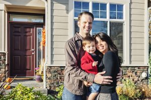 Miami Home Inspectors couple with their son standing in front of their house