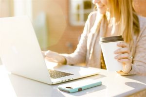 woman working in front of a laptop - home inspection Miami